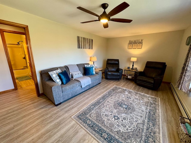 living room featuring wood-type flooring, ceiling fan, and a baseboard radiator