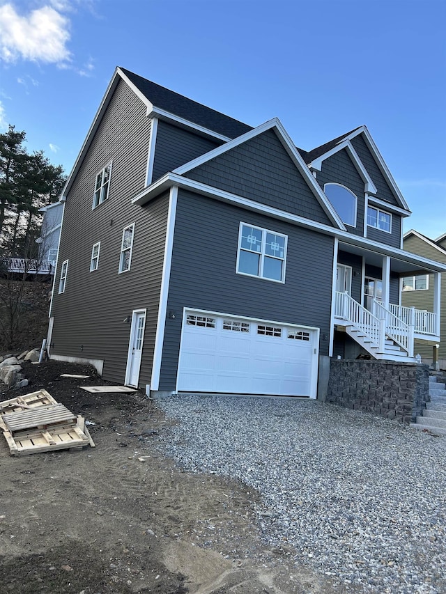 3 Mulligan Way Unit 3, Kingston, NH 03848 - view of home's exterior with an attached garage, driveway, covered porch, and stairway