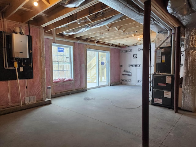 basement featuring heating unit and water heater