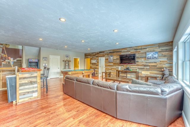 living room with billiards and light hardwood / wood-style flooring