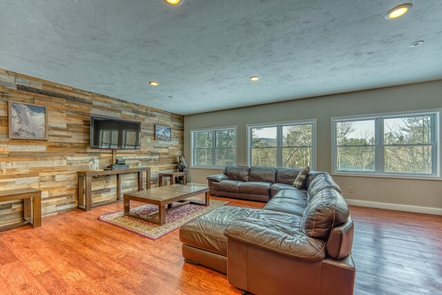 living room featuring wood walls and wood-type flooring