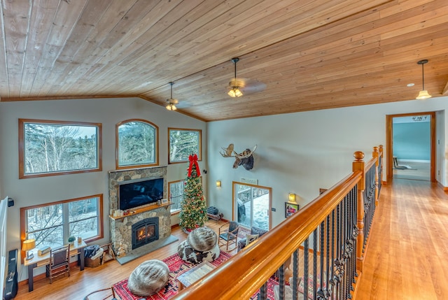 hallway featuring light hardwood / wood-style floors, wood ceiling, and vaulted ceiling