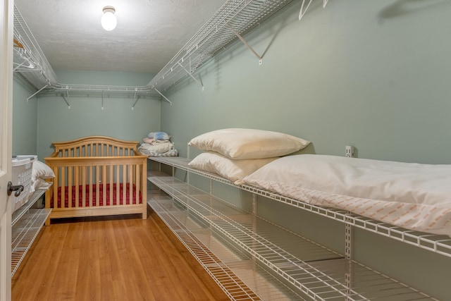 bedroom with wood-type flooring and a textured ceiling