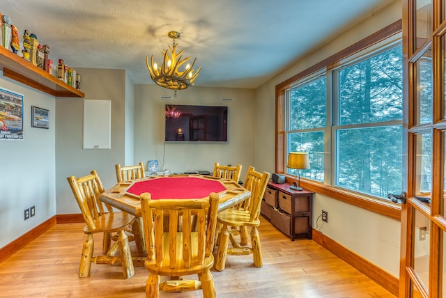 dining room with an inviting chandelier and light wood-type flooring