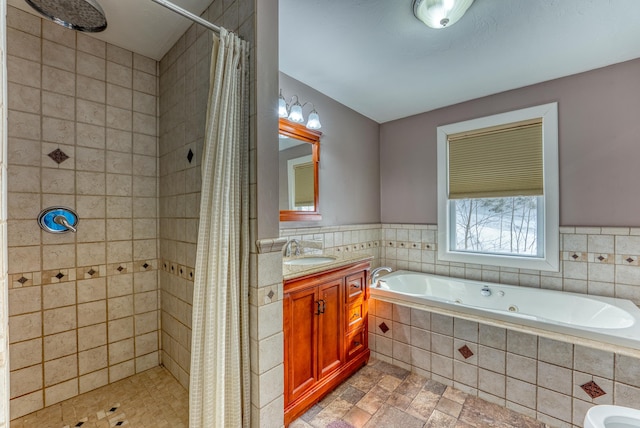 bathroom featuring tile walls, independent shower and bath, and vanity