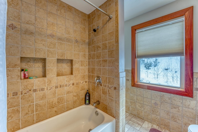 bathroom with tiled shower / bath and tile walls