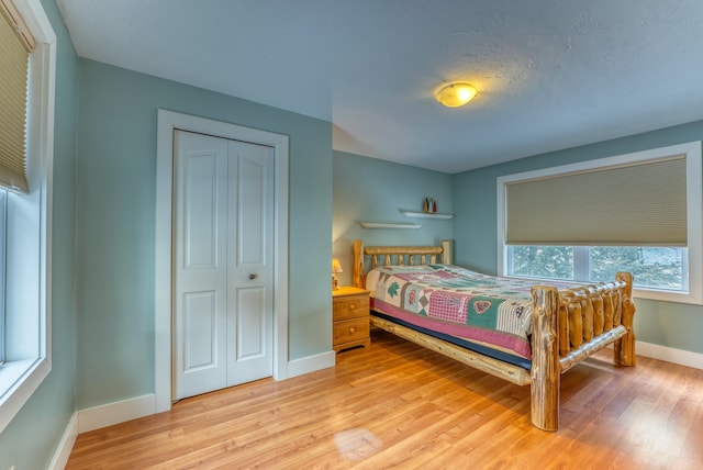 bedroom with a closet and light wood-type flooring