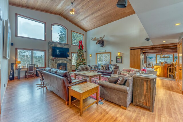 living room featuring plenty of natural light, light hardwood / wood-style flooring, and high vaulted ceiling