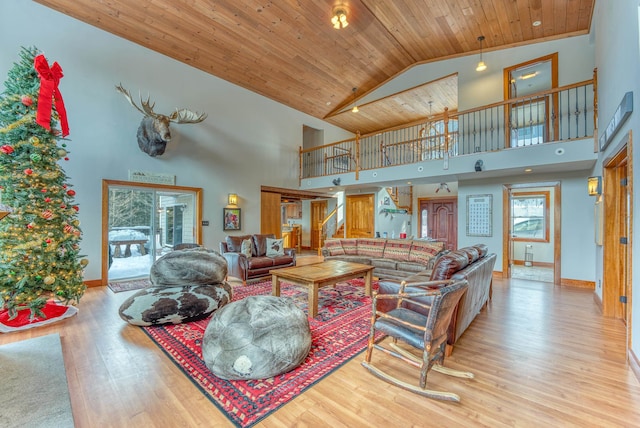 living room featuring high vaulted ceiling, light hardwood / wood-style flooring, and wooden ceiling