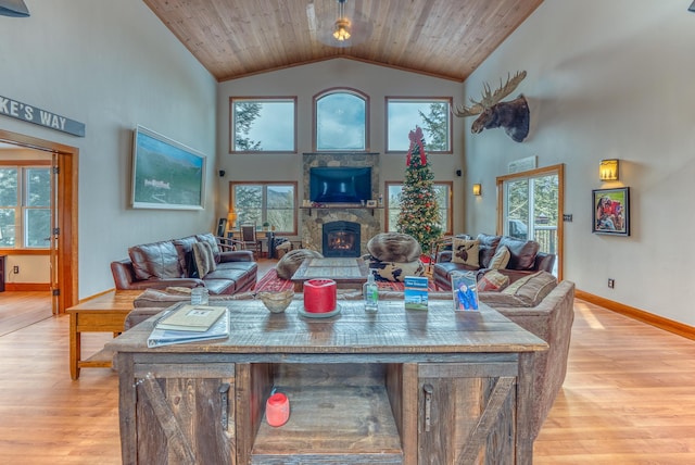 living room featuring a fireplace, a wealth of natural light, and light hardwood / wood-style flooring