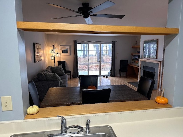 interior space featuring wood-type flooring, sink, and ceiling fan