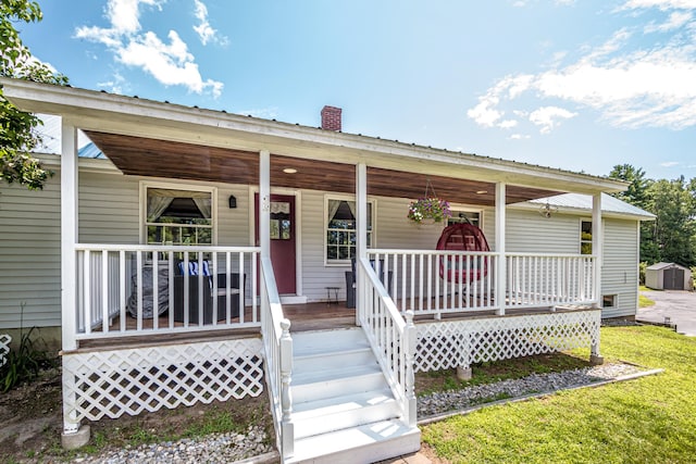 view of front facade with a front yard and covered porch