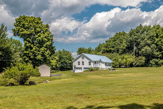 view of yard featuring a garage and a shed