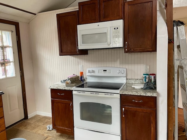 kitchen featuring light stone countertops, white appliances, and ornamental molding