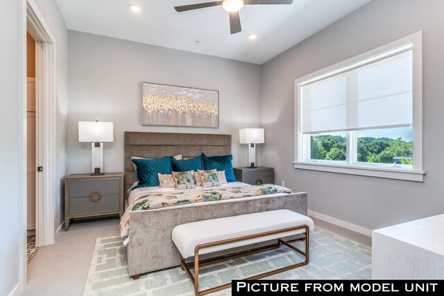 bedroom featuring ceiling fan and light carpet