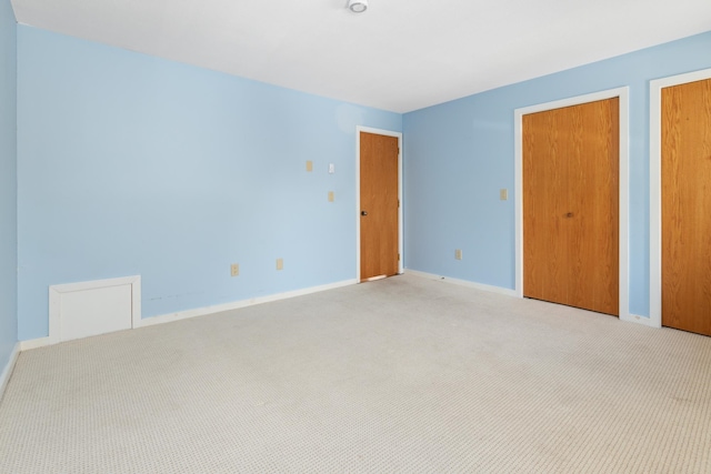 unfurnished bedroom with light colored carpet