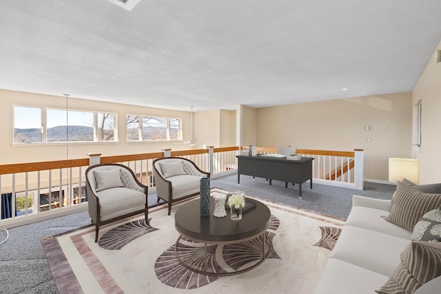 living room with carpet floors and a textured ceiling