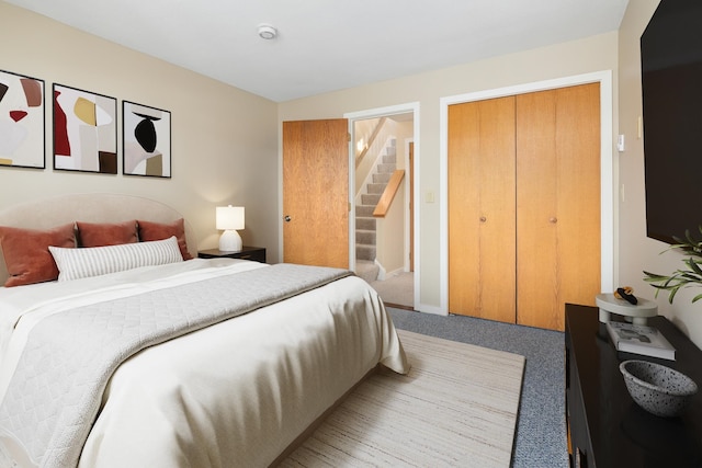 bedroom with a closet and light colored carpet