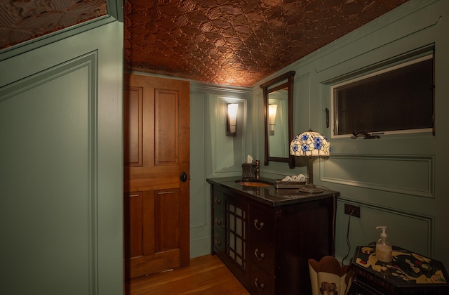 corridor featuring sink and hardwood / wood-style flooring