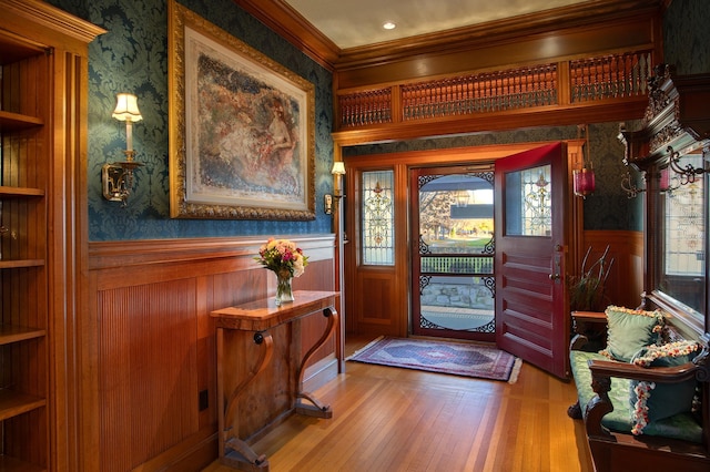 foyer featuring ornamental molding and hardwood / wood-style flooring