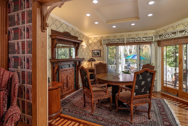 dining space with ornamental molding and hardwood / wood-style flooring