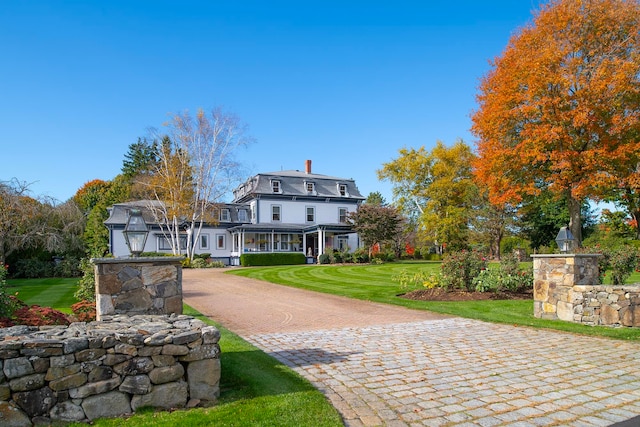 rear view of property featuring a yard