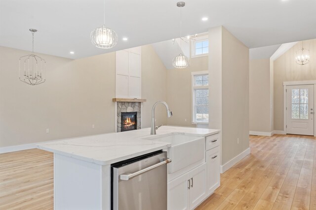 276 Sterling Dr, Laconia, NH 03246 - kitchen featuring dishwasher, a chandelier, a sink, a fireplace, and light wood finished floors