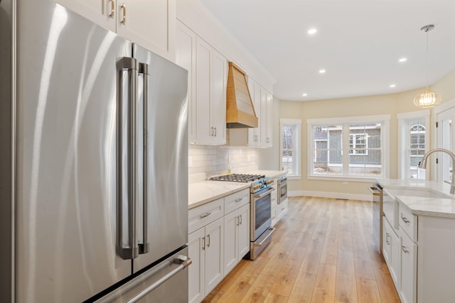 276 Sterling Dr, Laconia, NH 03246 - kitchen featuring stainless steel appliances, custom range hood, light wood-style flooring, white cabinetry, and recessed lighting