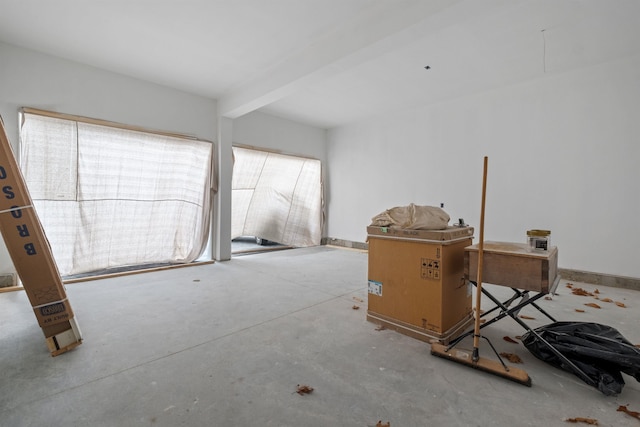 miscellaneous room featuring a wealth of natural light and beam ceiling