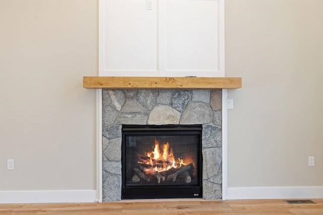 276 Sterling Dr, Laconia, NH 03246 - detailed view of a stone fireplace, baseboards, and wood finished floors