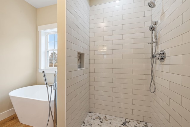 276 Sterling Dr, Laconia, NH 03246 - bathroom featuring tiled shower, a freestanding tub, and baseboards