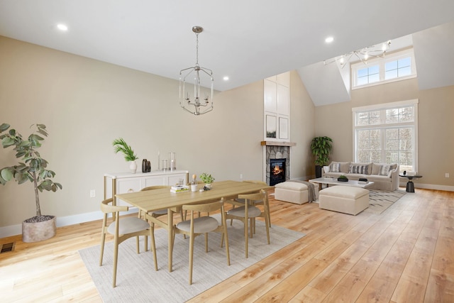 276 Sterling Dr, Laconia, NH 03246 - dining space featuring light wood-style floors, a fireplace, baseboards, recessed lighting, and a chandelier