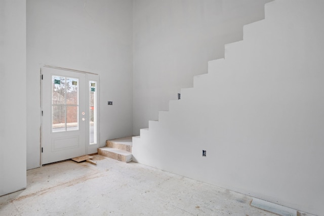 foyer featuring a towering ceiling