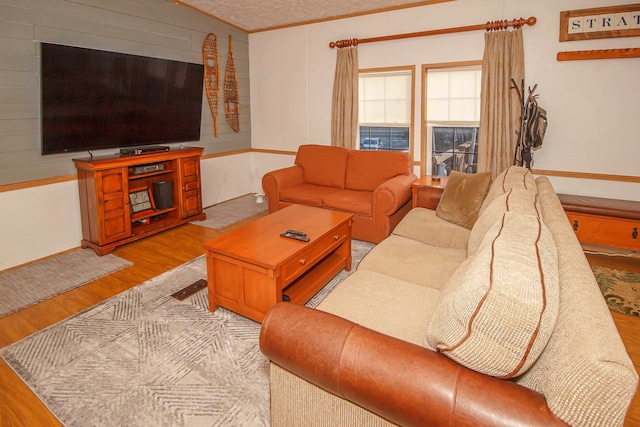 living room featuring light hardwood / wood-style flooring and ornamental molding