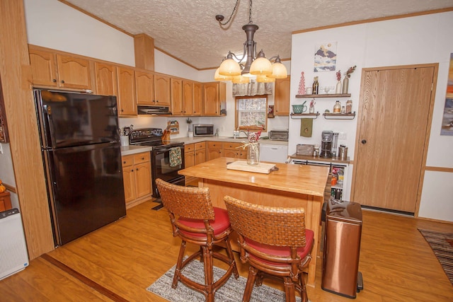 6738 Vt Route 100, Wardsboro, VT 05360 - kitchen featuring black appliances, decorative light fixtures, light wood-type flooring, and vaulted ceiling