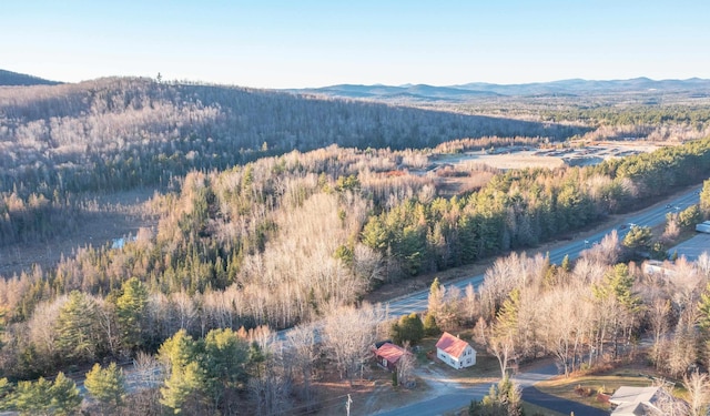 aerial view featuring a view of trees and a mountain view