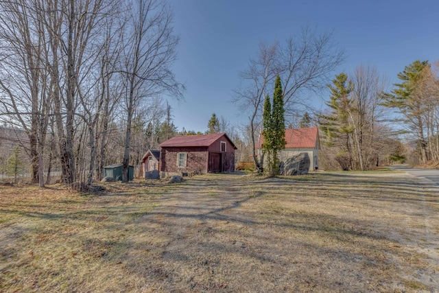 exterior space with an outdoor structure, a lawn, and a barn