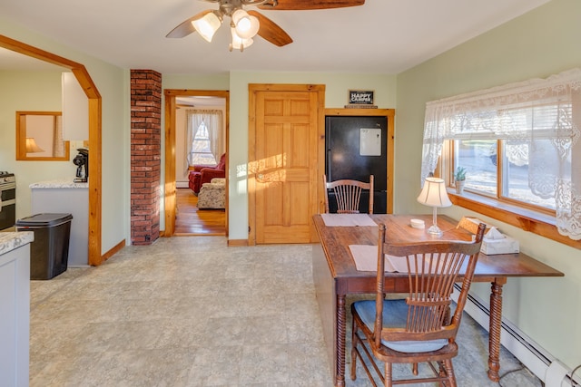dining space featuring a baseboard heating unit, baseboards, and ceiling fan