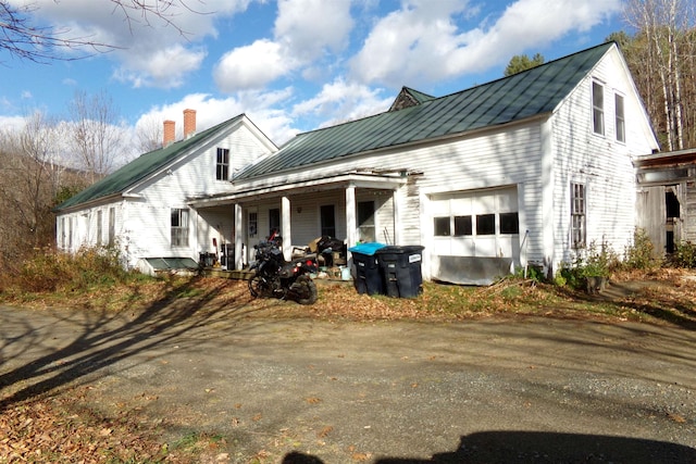 view of front of home featuring a porch and a garage