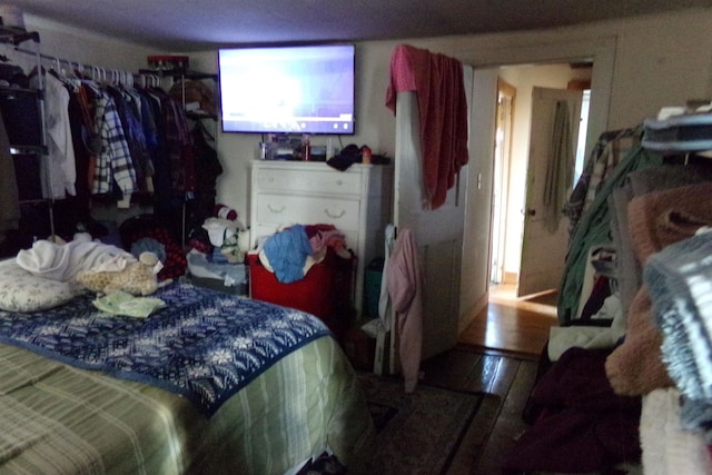 bedroom with hardwood / wood-style flooring