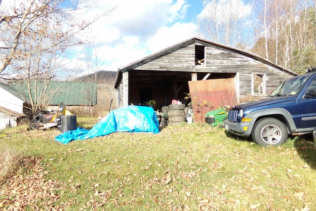 view of outbuilding featuring a lawn