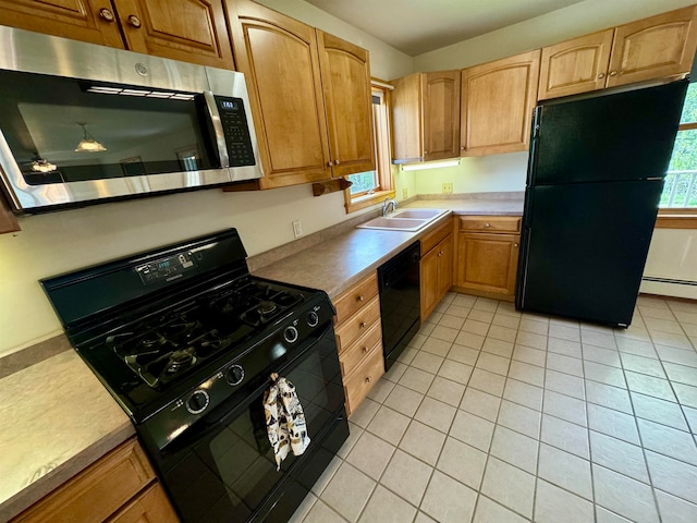 kitchen with baseboard heating, black appliances, light tile patterned floors, and sink