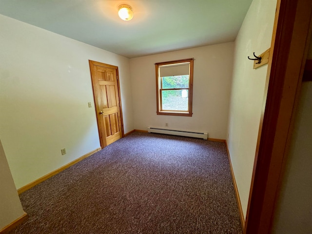 spare room with a baseboard heating unit and carpet floors