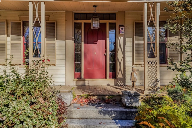 view of exterior entry featuring covered porch