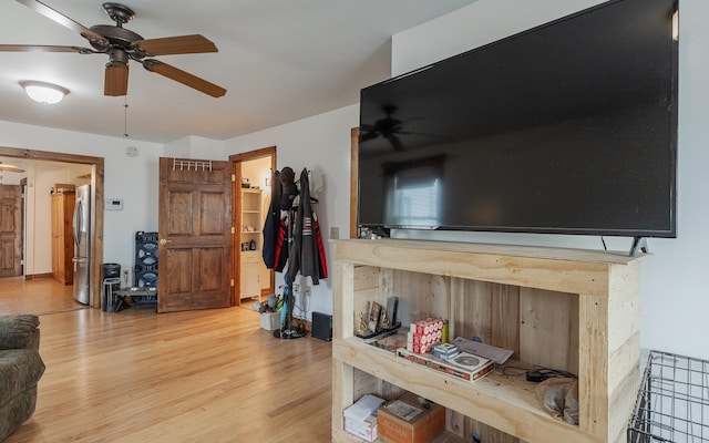 living room featuring hardwood / wood-style flooring and ceiling fan