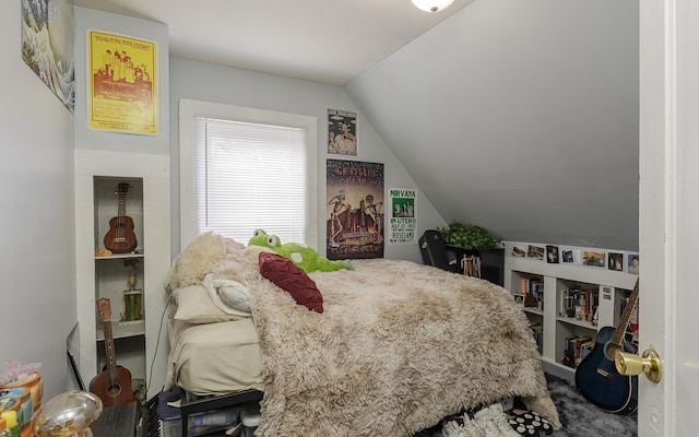 bedroom featuring carpet flooring and vaulted ceiling