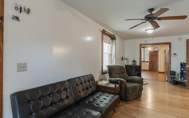 living room featuring ceiling fan and light wood-type flooring