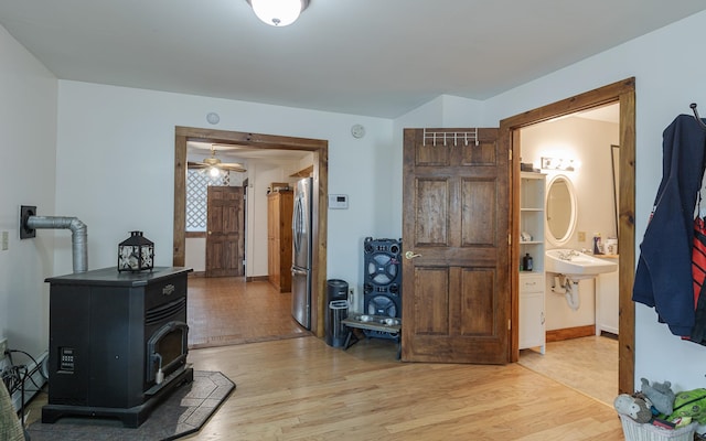 corridor with hardwood / wood-style floors and sink