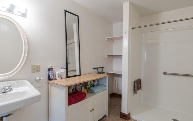 bathroom with walk in shower and sink