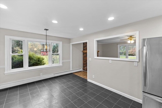 unfurnished dining area with a baseboard radiator, a wealth of natural light, and ceiling fan